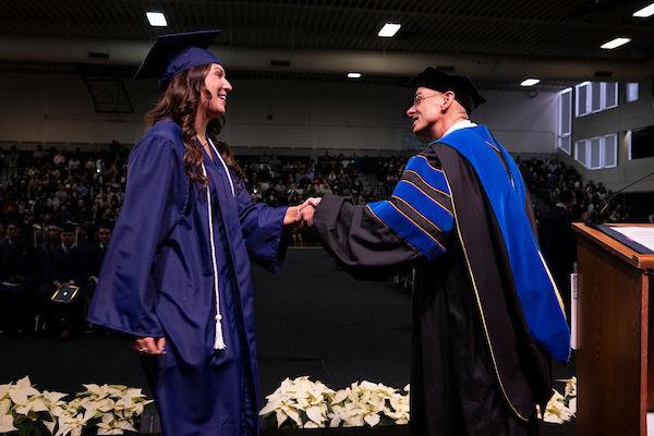 Student shaking chancellors hand at commencement